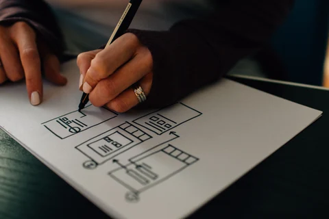 Hands sketching interface wireframe