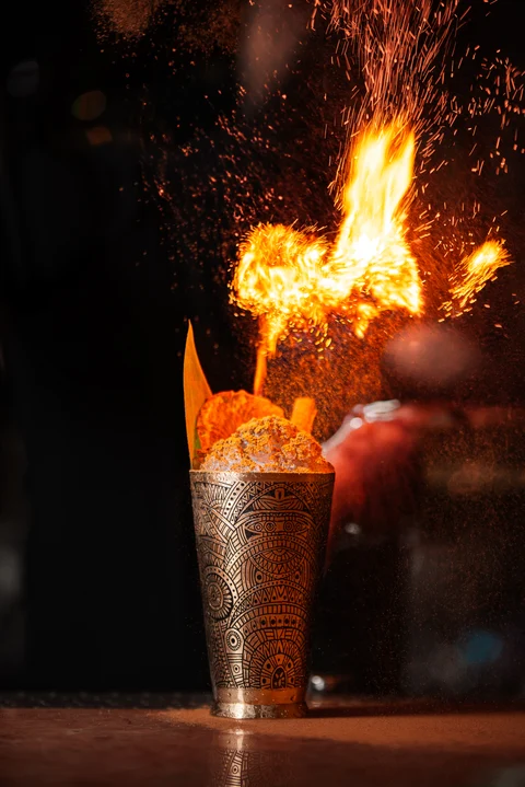 Flaming cocktail with scattered sparks