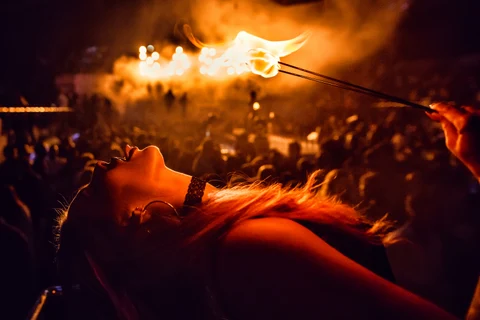 Fire performer leaning under flame