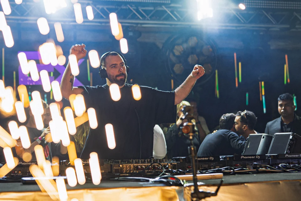 Dj raised arms flying sparks