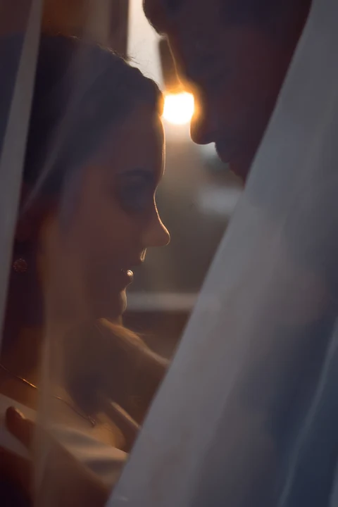 Veiled couple sunset profiles