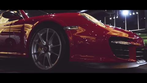 A red sports car displayed inside a showroom.