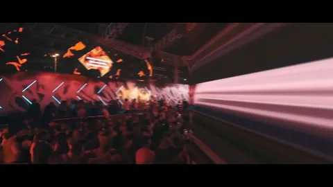 Beams of light crossing a packed performance venue.