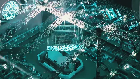 An illuminated calligraphic installation inside a large venue.